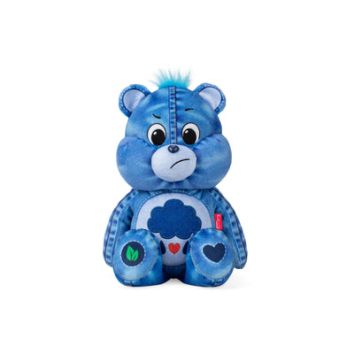 Blue teddy bear plush toy with a white heart on a white background