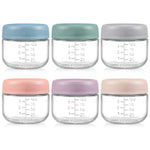 Set of six glass jars with colorful lids on a white background