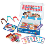 Children's game set with donut-themed packaging, toys, and cards on a white background