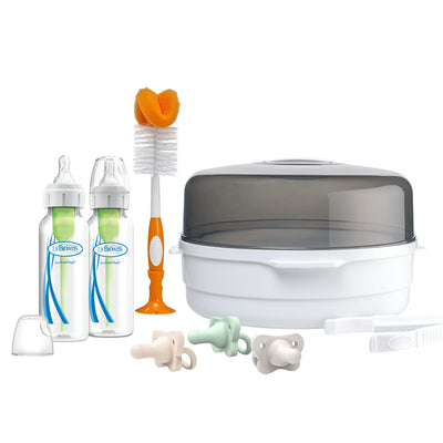 Baby bottle set with bottles, brush, and containers on a white background