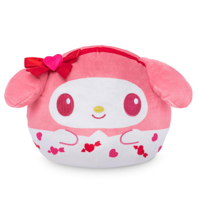 Pink plush toy with red bow and heart patterns on a white background