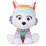 Plush toy dog with a colorful rainbow hat on a white background