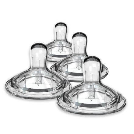 Set of four clear baby bottle nipples on a white background