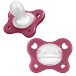Two pink baby pacifiers on a white background