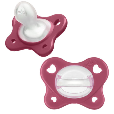 Two pink baby pacifiers on a white background