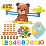 Balancing bear toy with additional items including teddy bear figures, colorful buttons, and number cards on a white background.