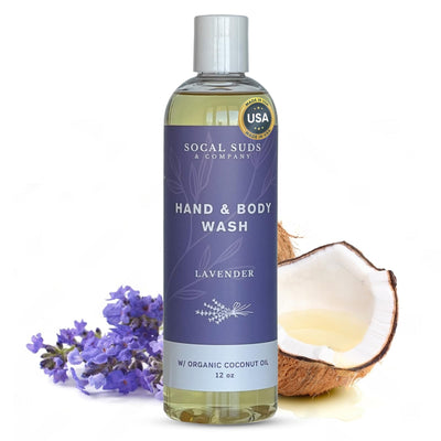 Bottle of Socal Suds lavender hand and body wash with lavender flowers and a coconut on a white background
