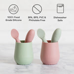Two silicone cups with spoons, featuring safety certifications on a white background.