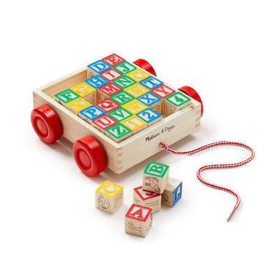 Wooden toy with colorful alphabet blocks and red wheels on a white background