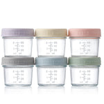 Set of six glass containers with colorful lids on a white background