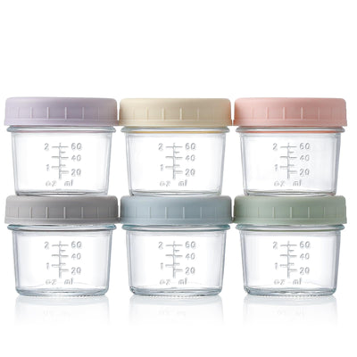Set of six glass containers with colorful lids on a white background
