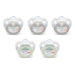 Set of five NUK pacifiers on a white background