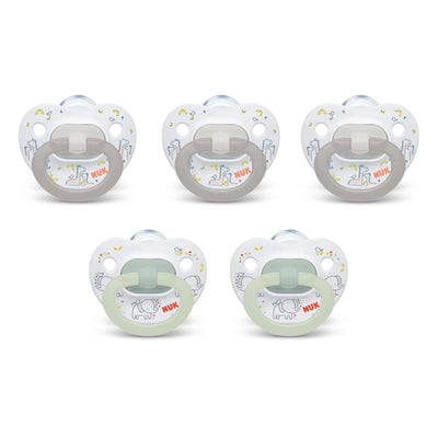 Set of five NUK pacifiers on a white background