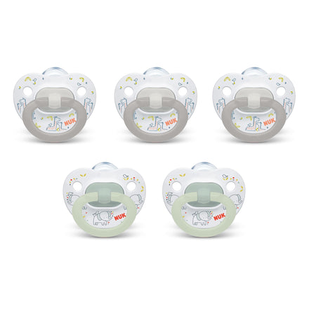 Set of five NUK pacifiers on a white background