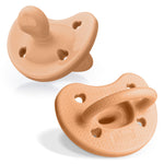 Two beige silicone pacifiers on a white background
