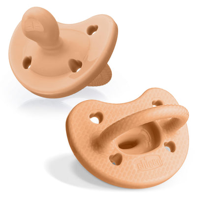 Two beige silicone pacifiers on a white background