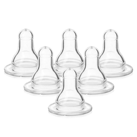 Set of six clear baby bottle nipples on a white background