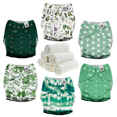Set of green and white patterned cloth diapers with a roll of white cloth on a white background