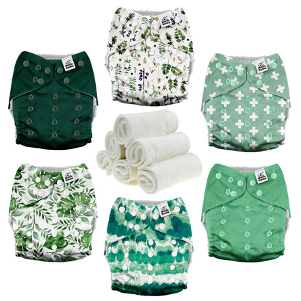 Set of green and white patterned cloth diapers with a roll of white cloth on a white background