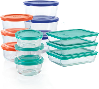 Set of clear food storage containers with colorful lids on a white background