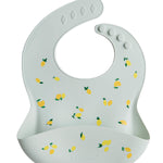 Light blue baby bib with lemon pattern on a white background