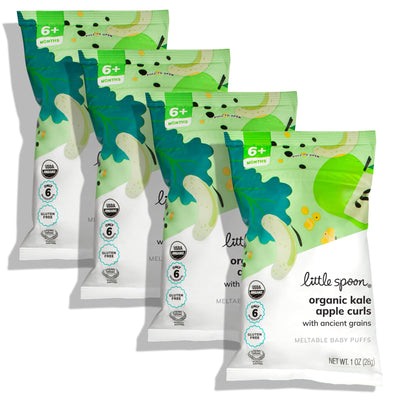 Four packages of Little Spoon organic kale apple curls on a white background