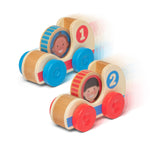 Wooden toy with colorful wheels and face cutouts on a white background