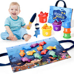 Child playing with colorful fishing toys and accessories on a white background