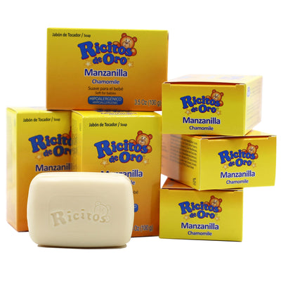 Multiple boxes of Ricitos de Oro Manzanilla Chamomile soap with a single bar of soap in front.