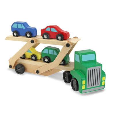 Wooden toy car carrier with green truck and colorful cars on a white background