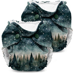Two patterned diapers with starry night and forest design on a white background