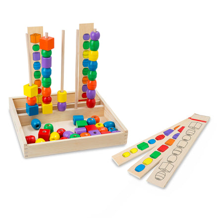 Colorful wooden educational toy with beads and pegs on a white background
