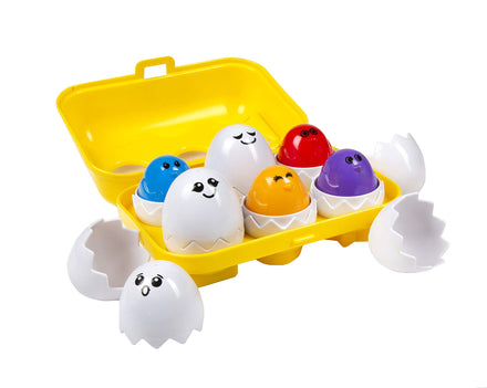Colorful toy eggs with faces in a yellow egg carton on a white background