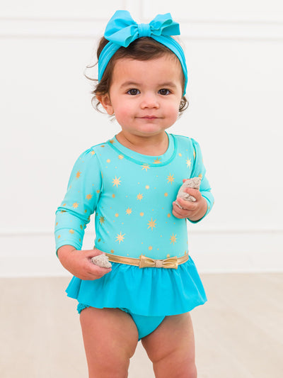 RuffleButts Baby Girls UPF50+ Princess Long Sleeve Bow Skirted One Piece Swimsuit - Teal Golden Princess, 6-12m