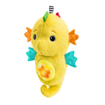 Yellow plush toy resembling a seahorse on a white background