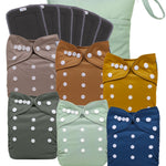 Set of colorful cloth diapers with bow designs on a white background
