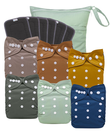 Set of colorful cloth diapers with bow designs on a white background