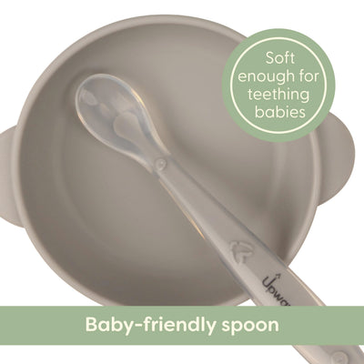 Baby-friendly spoon with soft handle for teething babies, on a white background.