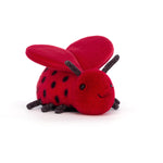 Red plush ladybug toy on a white background