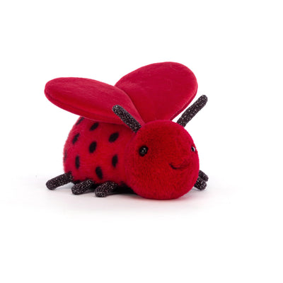Red plush ladybug toy on a white background