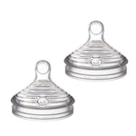 Two clear baby bottle nipples on a white background