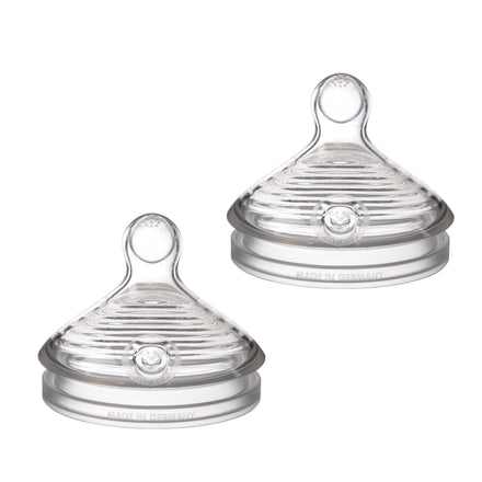 Two clear baby bottle nipples on a white background