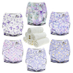Set of patterned cloth diapers with a stack of white pads on a white background