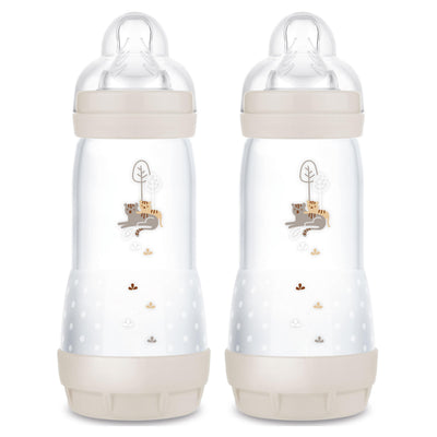 Two baby bottles with decorative elements on a white background