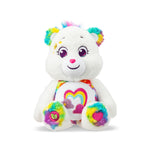 White plush toy with rainbow accents on a white background