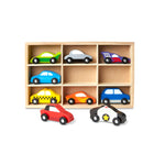 Set of colorful toy cars on a wooden shelf with a white background
