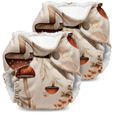 Two mushroom-patterned cloth diapers on a white background