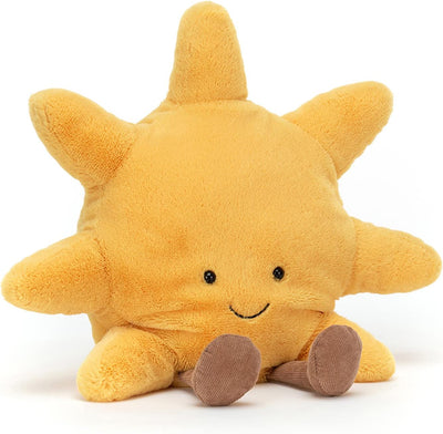 Yellow plush sun toy with a smiling face on a white background