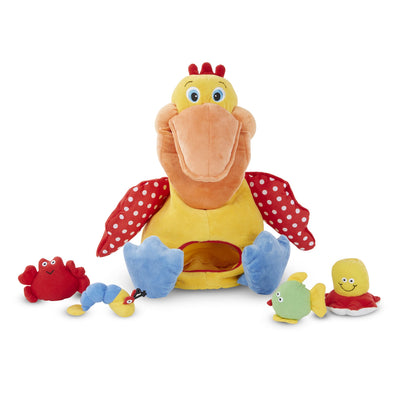 Plush toy with a large bird-like figure and smaller sea creature toys on a white background