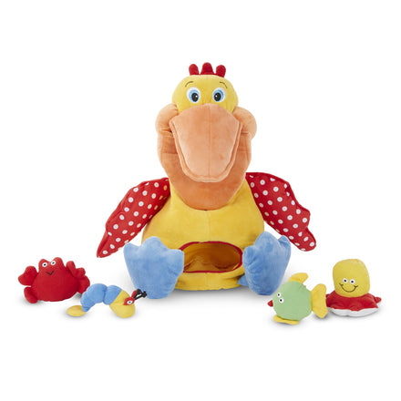 Plush toy with a large bird-like figure and smaller sea creature toys on a white background